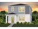 Charming two-story home with gray siding, white trim, and well-manicured landscaping at 6951 Copperwood Ave, Orlando, FL 32829
