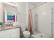 Well-maintained bathroom featuring a vanity with granite countertop and a step-in shower at 7041 Oakwood St, Davenport, FL 33837