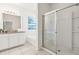 Bright bathroom featuring a granite countertop, undermount sink and a glass-enclosed shower at 7041 Oakwood St, Davenport, FL 33837