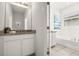 Clean, bright bathroom featuring a double vanity with granite top and a separate soaking tub at 7041 Oakwood St, Davenport, FL 33837