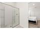 Modern bathroom with a glass-enclosed shower and tiled walls at 7041 Oakwood St, Davenport, FL 33837