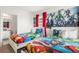 Bright bedroom with two twin beds, superhero themed decor and red accent curtains at 7041 Oakwood St, Davenport, FL 33837