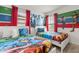 Colorful themed room with two twin beds, superhero decor and red accent curtains at 7041 Oakwood St, Davenport, FL 33837