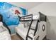 bedroom with a bunk bed and a Little Mermaid themed wall mural at 7041 Oakwood St, Davenport, FL 33837