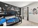 Themed bedroom with a bunk bed, space themed decor and a window at 7041 Oakwood St, Davenport, FL 33837