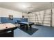 Spacious garage converted into a game room, complete with air hockey and pool table for entertainment at 7041 Oakwood St, Davenport, FL 33837
