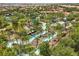 An aerial view showcases a community's scenic lazy river surrounded by lush greenery at 7041 Oakwood St, Davenport, FL 33837