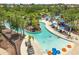 An aerial view of a lazy river winding through a community with lounge chairs at 7041 Oakwood St, Davenport, FL 33837