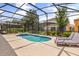 Relaxing screened-in pool and spa with lounge chairs create a private outdoor oasis at 7041 Oakwood St, Davenport, FL 33837