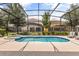 Inviting private screened-in pool and spa, perfect for outdoor relaxation and enjoyment in the backyard oasis at 7041 Oakwood St, Davenport, FL 33837