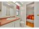 Bright bathroom with a view into the bedroom featuring a vanity and a toilet at 750 Polo Park Blvd, Davenport, FL 33897