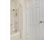 Bathroom featuring a white tub with shower and a white door at 750 Polo Park Blvd, Davenport, FL 33897