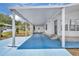A spacious carport leads to the entrance of this charming home with a blue painted drive at 750 Polo Park Blvd, Davenport, FL 33897