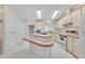 Well-lit kitchen showcasing an island, classic appliances, and ample cabinet space at 750 Polo Park Blvd, Davenport, FL 33897