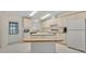 Cozy kitchen featuring white cabinetry, a center island, and standard appliances at 750 Polo Park Blvd, Davenport, FL 33897