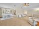 Open-concept living and dining area with neutral tones, a chandelier, and carpeted floors at 750 Polo Park Blvd, Davenport, FL 33897