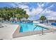 Community pool surrounded by lounge chairs and tables, perfect for relaxation and recreation at 750 Polo Park Blvd, Davenport, FL 33897