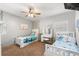 Brightly lit bedroom with twin beds, ceiling fan and desk area at 793 Greenway Pl, Daytona Beach, FL 32114