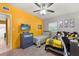 Bright bedroom with twin beds, ceiling fan, dresser and wall mounted television at 793 Greenway Pl, Daytona Beach, FL 32114