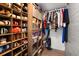 Closet with many pairs of shoes organized on wood shelving and clothing racks at 793 Greenway Pl, Daytona Beach, FL 32114