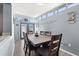 Bright dining area with a large table, wood floors, and access to the outdoors through blue double doors at 793 Greenway Pl, Daytona Beach, FL 32114