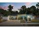 Charming single-story home with a covered outdoor seating area and well-maintained landscaping at 793 Greenway Pl, Daytona Beach, FL 32114