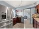 Modern kitchen with stainless steel appliances, wood cabinetry, and convenient counter space at 793 Greenway Pl, Daytona Beach, FL 32114