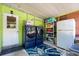 Bright Laundry Room with appliances, storage shelving and access to backyard at 793 Greenway Pl, Daytona Beach, FL 32114