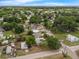 An aerial view shows a neighborhood with tree-lined streets and single-Gathering homes on well-maintained lots at 803 Jersey Ave, St Cloud, FL 34769