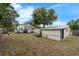 A spacious backyard with a shed, mature trees, and lush greenery at 803 Jersey Ave, St Cloud, FL 34769