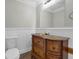 Traditional half bathroom featuring a wood vanity with marble countertop and a decorative mirror at 803 Jersey Ave, St Cloud, FL 34769