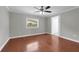 Cozy bedroom with hardwood floors and a ceiling fan at 803 Jersey Ave, St Cloud, FL 34769