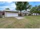 Charming home and detached garage in a suburban neighborhood with green lawn and mature landscaping at 803 Jersey Ave, St Cloud, FL 34769