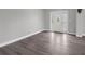 Bright foyer featuring modern flooring, fresh paint, and an elegant front door with decorative glass at 803 Jersey Ave, St Cloud, FL 34769