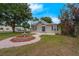 A home featuring manicured landscaping and a charming decorative fountain leading to the front entrance at 803 Jersey Ave, St Cloud, FL 34769