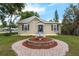 Charming home featuring a manicured lawn with a lovely decorative fountain feature at the entrance at 803 Jersey Ave, St Cloud, FL 34769