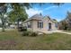 A quaint home with a manicured lawn featuring charming landscaping around the front porch and yard at 803 Jersey Ave, St Cloud, FL 34769