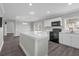 Updated kitchen boasts granite countertops, white cabinetry, and modern stainless steel appliances at 803 Jersey Ave, St Cloud, FL 34769