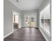 Bright living room with French doors to the backyard and an ensuite bathroom with a glass block window at 803 Jersey Ave, St Cloud, FL 34769