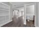 Open-concept living space with hardwood floors and view into an adjacent living room and a half bathroom at 803 Jersey Ave, St Cloud, FL 34769