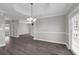 Spacious living room with hardwood flooring, stylish lighting, and a neutral color palette at 803 Jersey Ave, St Cloud, FL 34769