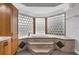 Relaxing bathroom with soaking tub and glass block window at 803 Jersey Ave, St Cloud, FL 34769