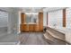Luxurious bathroom with dual vanities, glass shower, and jacuzzi tub with glass block window at 803 Jersey Ave, St Cloud, FL 34769