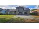 Home's rear exterior shows a concrete patio and green yard, surrounded by a wood fence at 8612 Valley Ridge Ct, Orlando, FL 32818