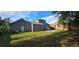 Expansive backyard featuring a concrete patio, grassy area, wood fence and the home's exterior at 8612 Valley Ridge Ct, Orlando, FL 32818