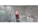 Modern bathroom features double vanities, a glass enclosed shower and marble tiling at 8612 Valley Ridge Ct, Orlando, FL 32818