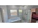 Modern bathroom features a soaking tub, glass enclosed shower, and updated vanity at 8612 Valley Ridge Ct, Orlando, FL 32818