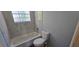 Bathroom features a bathtub with tile and a dual-flush toilet at 8612 Valley Ridge Ct, Orlando, FL 32818