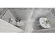 Full bathroom featuring white marbled tile, a sink, and a toilet with a toilet brush at 8612 Valley Ridge Ct, Orlando, FL 32818