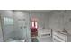 Modern bathroom features double vanities, a glass enclosed shower and marble tiling at 8612 Valley Ridge Ct, Orlando, FL 32818